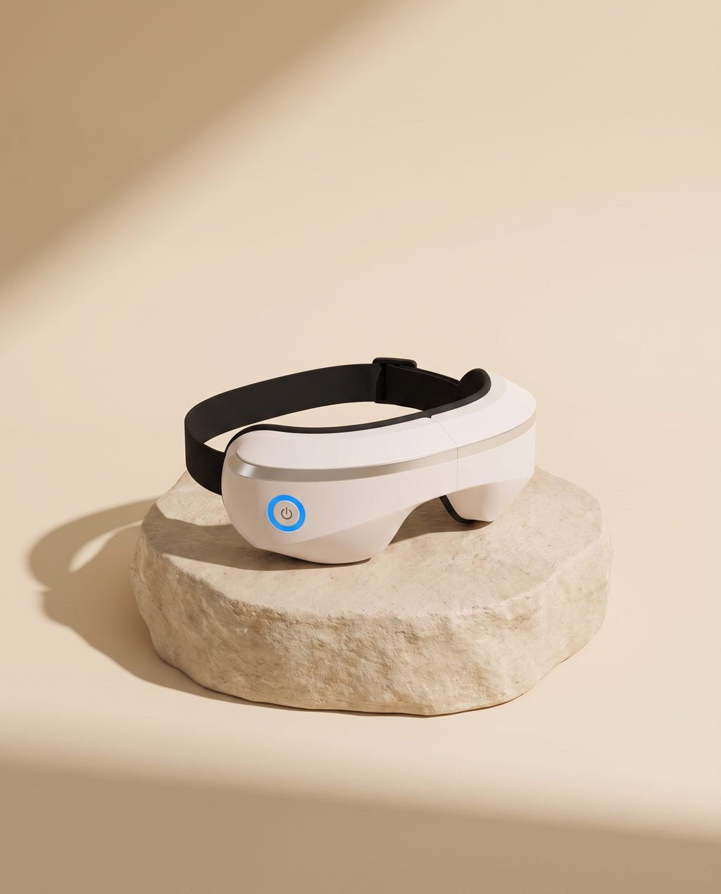 Smart Eye Massager on a beige stone podium, cream studio backdrop