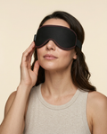 Model wearing the Wellness on Screen heated eye mask against a warm cream studio backdrop
